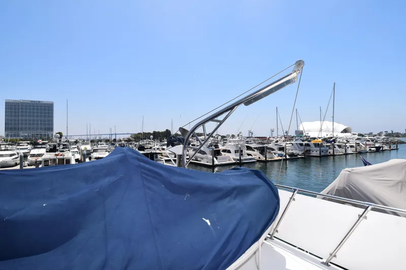 Slide: The Image of 1988 Sea Ranger 51 Motor Yacht docked in a marina, surrounded by other boats under a clear blue sky. - 19