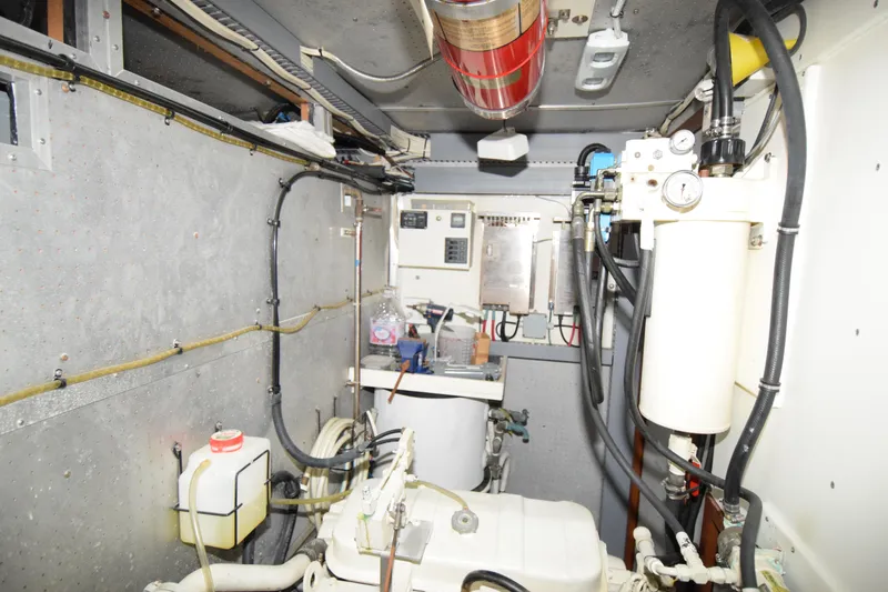 Slide: The Image of Engine room of 1988 Sea Ranger 51 Motor Yacht with mechanical components and wiring. - 22