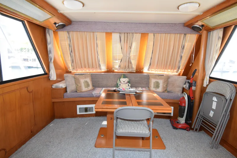 Slide: The Image of Interior of 1988 Sea Ranger 51 Motor Yacht with cozy seating and dining area. - 3