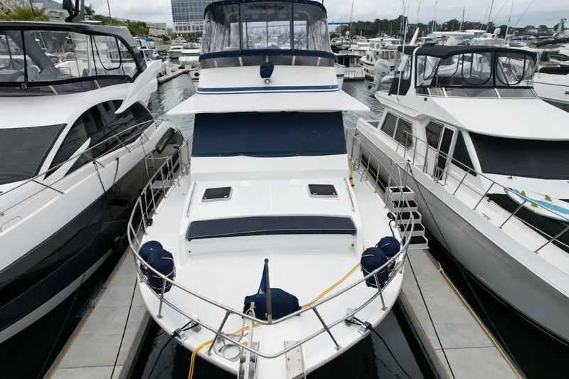 Slide: The Image of 1988 Sea Ranger 51 Motor Yacht docked at marina, surrounded by other boats. - 31