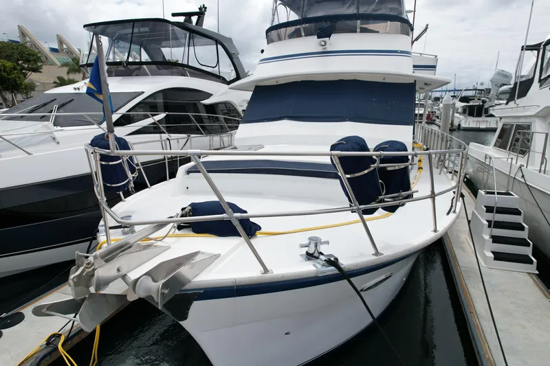 Slide: The Image of 1988 Sea Ranger 51 Motor Yacht docked at marina, featuring spacious deck and sleek design. - 32