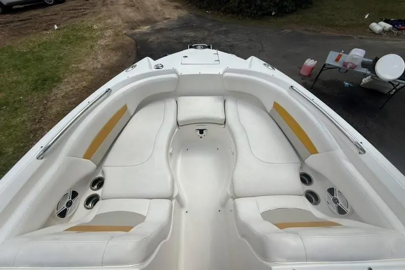 Slide: The Image of 2009 Chaparral Sunesta 244 Xtreme boat interior with white seating and cup holders. - 11