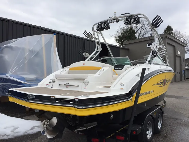 Slide: The Image of 2009 Chaparral Sunesta 244 Xtreme boat on trailer, yellow and white. - 2