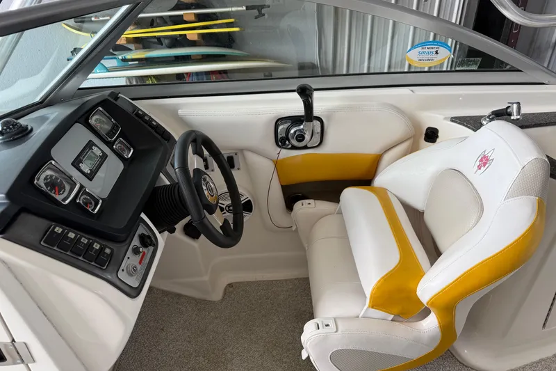 Slide: The Image of 2009 Chaparral Sunesta 244 Xtreme boat interior with steering wheel and control panel. - 8