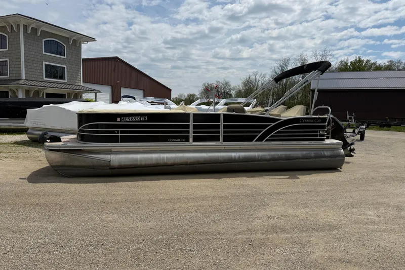 The Image of 2014 Cypress Cay Cozumel 240 pontoon boat parked on gravel near buildings. - 1