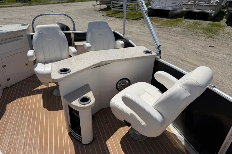 Slide: The Image of 2014 Cypress Cay Cozumel 240 boat interior with white seating and cup holders. - 13