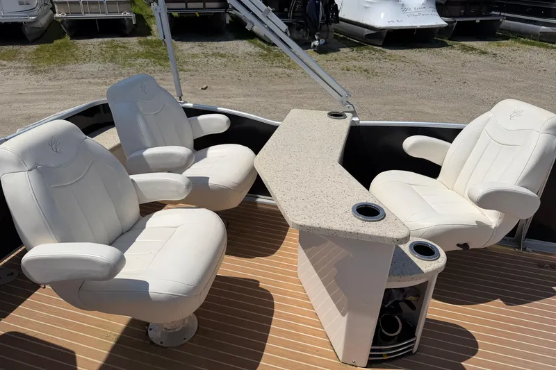 Slide: The Image of 2014 Cypress Cay Cozumel 240 boat interior with white seating and a central table. - 14