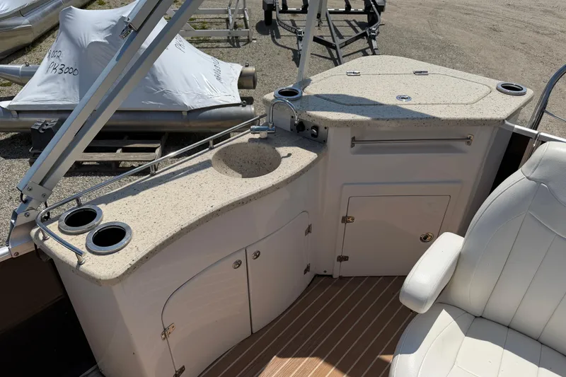 Slide: The Image of 2014 Cypress Cay Cozumel 240 boat interior with sink, cup holders, and seating. - 15