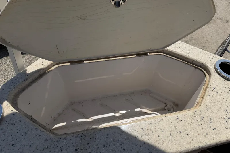 Slide: The Image of Open storage compartment on a 2014 Cypress Cay Cozumel 240 boat. - 16