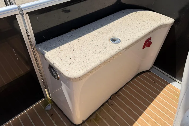 Slide: The Image of 2014 Cypress Cay Cozumel 240 boat interior with a speckled countertop and wooden flooring. - 19