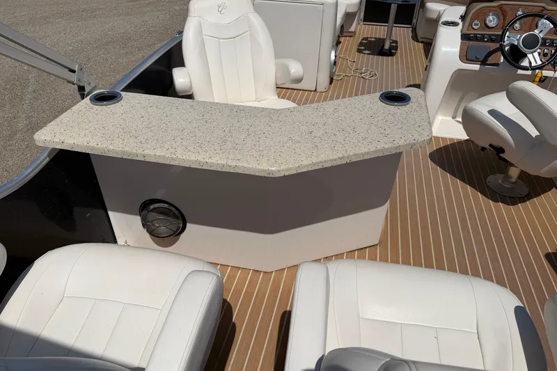 Slide: The Image of 2014 Cypress Cay Cozumel 240 boat interior with white seating and a granite-style counter. - 21