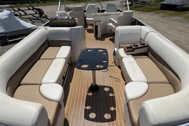 Slide: The Image of 2014 Cypress Cay Cozumel 240 pontoon boat interior with beige seating and central table. - 5
