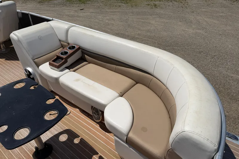 Slide: The Image of 2014 Cypress Cay Cozumel 240 boat interior with beige seating and cup holders. - 6