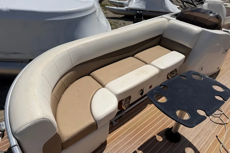 Slide: The Image of 2014 Cypress Cay Cozumel 240 boat interior with beige seating and cup holder table. - 7