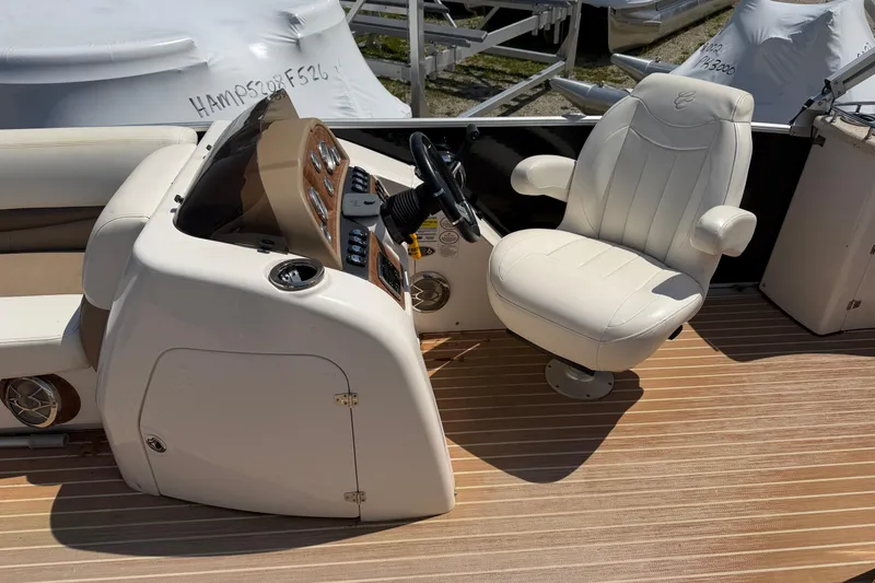 Slide: The Image of 2014 Cypress Cay Cozumel 240 boat helm with white captain's chair and control panel. - 8
