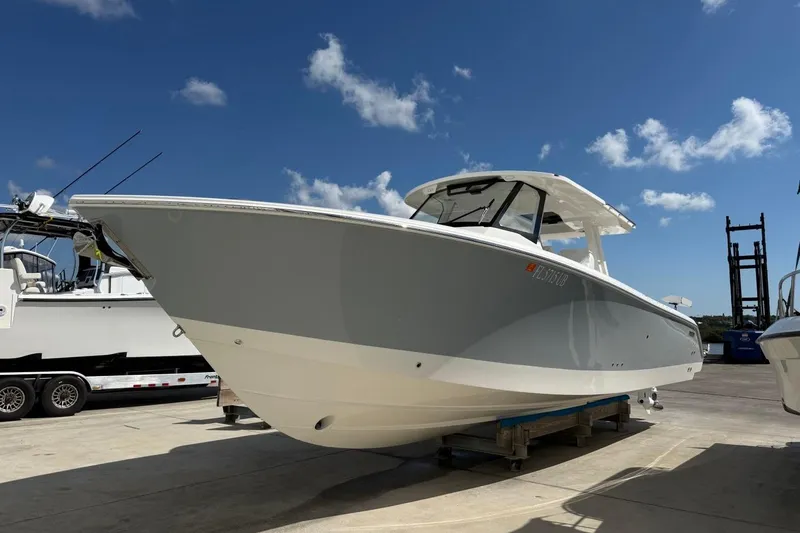 The Image of 2026 Pursuit S 358 Sport boat on display under a clear blue sky. - 0