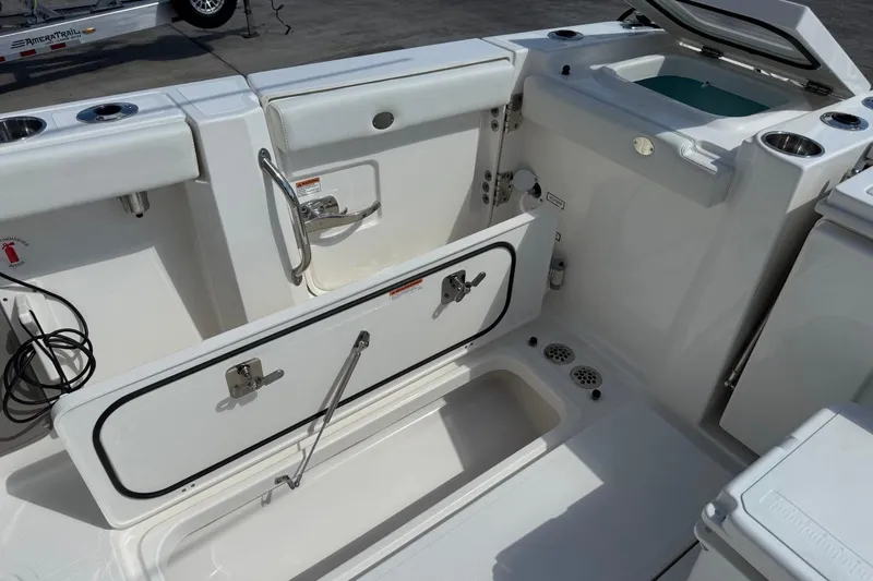 Slide: The Image of 2026 Pursuit S 358 Sport boat interior with open storage compartments and seating. - 10
