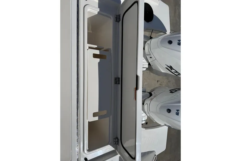 Slide: The Image of Open storage compartment on 2026 Pursuit S 358 Sport boat with dual engines. - 13