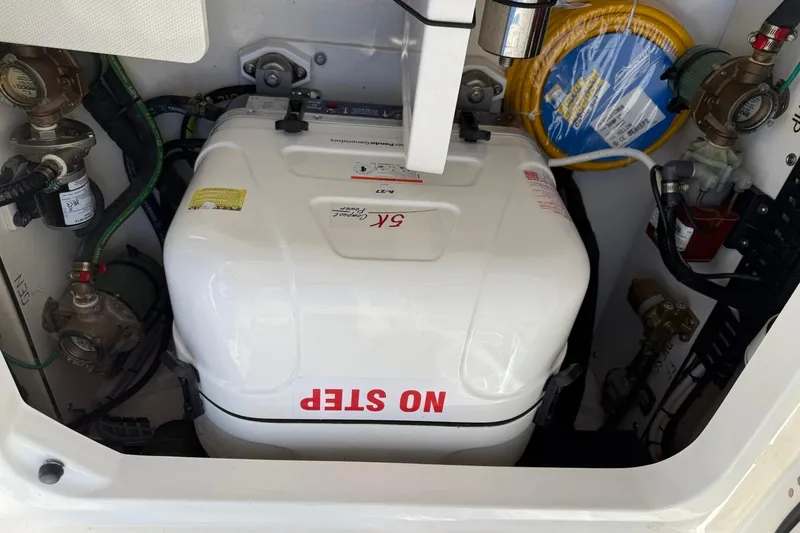 Slide: The Image of Engine compartment of 2026 Pursuit S 358 Sport boat with generator and hoses. - 14