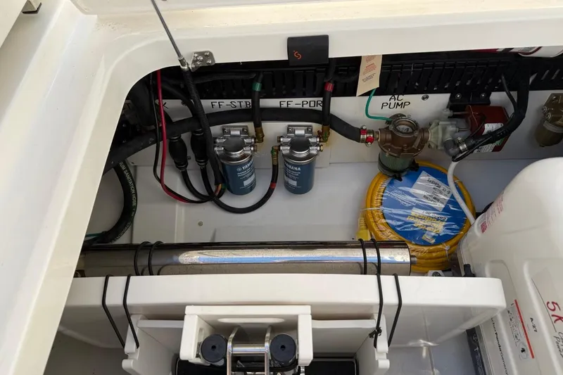 Slide: The Image of Engine compartment of 2026 Pursuit S 358 Sport boat, showcasing filters and AC pump. - 15