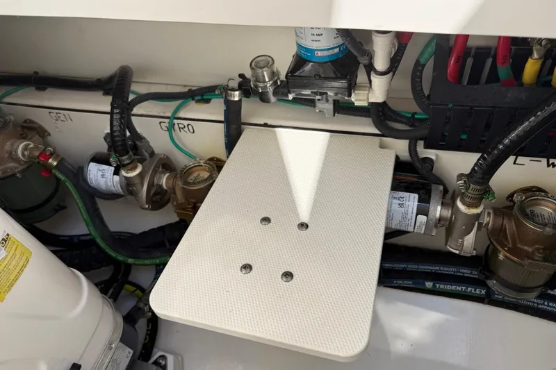 Slide: The Image of Engine compartment of 2026 Pursuit S 358 Sport boat with visible wiring and components. - 16