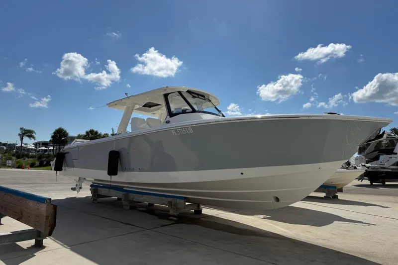 Slide: The Image of 2026 Pursuit S 358 Sport boat on display under a clear blue sky. - 2