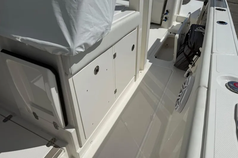 Slide: The Image of 2026 Pursuit S 358 Sport boat interior with storage compartments and seating area. - 27