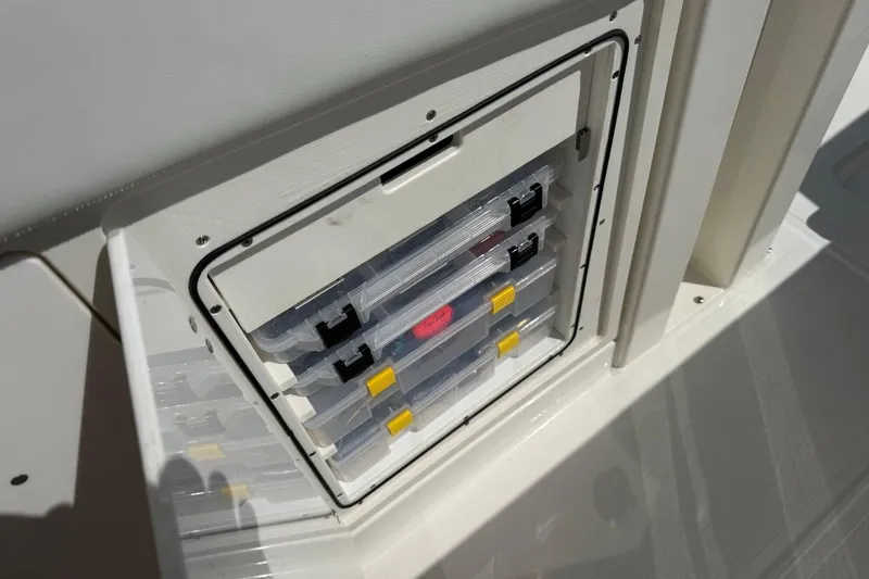 Slide: The Image of Storage compartment with organized tackle boxes on a 2026 Pursuit S 358 Sport boat. - 28