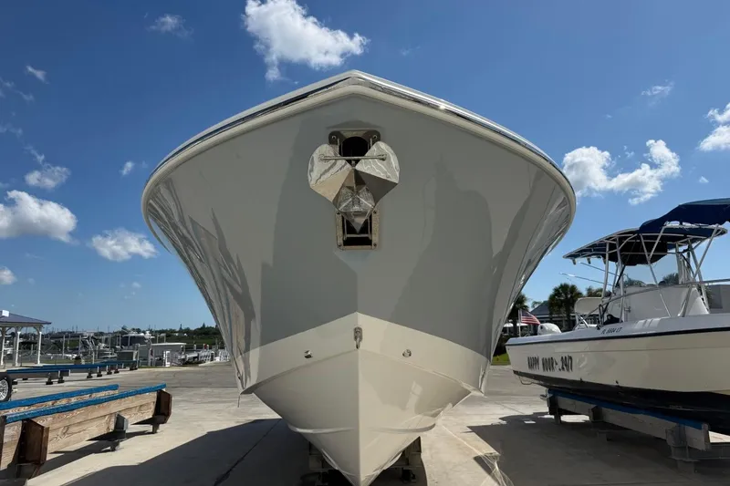 Slide: The Image of 2026 Pursuit S 358 Sport boat on display under a clear blue sky. - 3