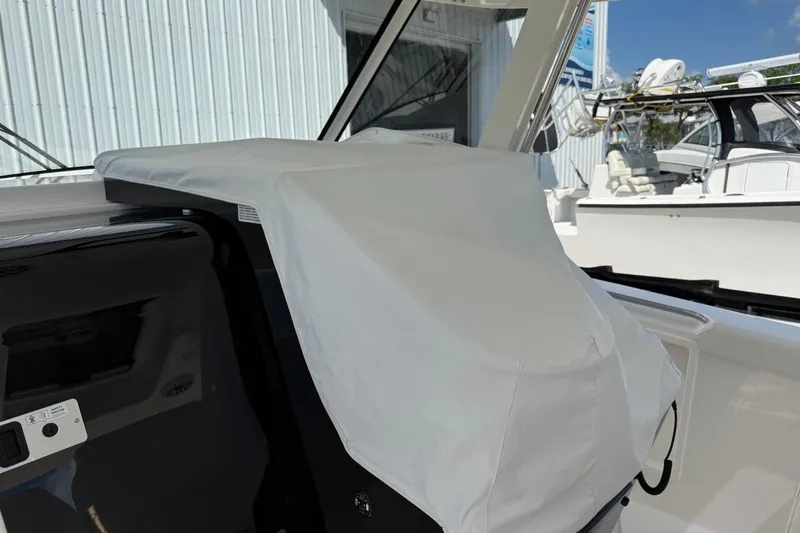 Slide: The Image of 2026 Pursuit S 358 Sport boat helm covered with protective fabric. - 31