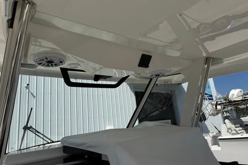 Slide: The Image of 2026 Pursuit S 358 Sport boat interior with speakers and sleek design elements. - 32