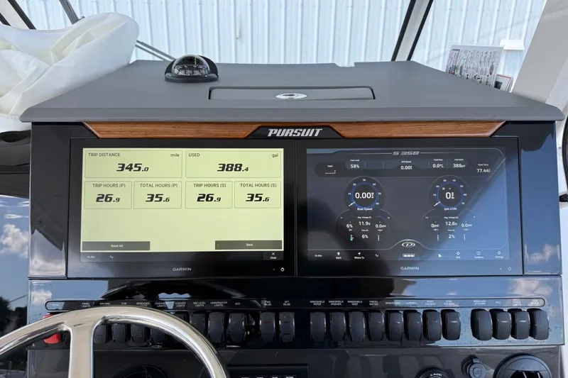Slide: The Image of Dashboard of 2026 Pursuit S 358 Sport boat with digital displays and controls. - 37