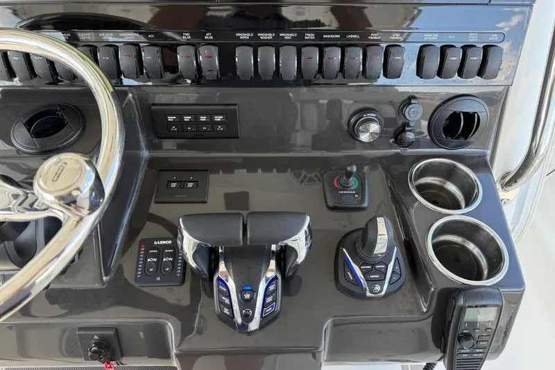 Slide: The Image of Control panel of 2026 Pursuit S 358 Sport boat with steering wheel and switches. - 38