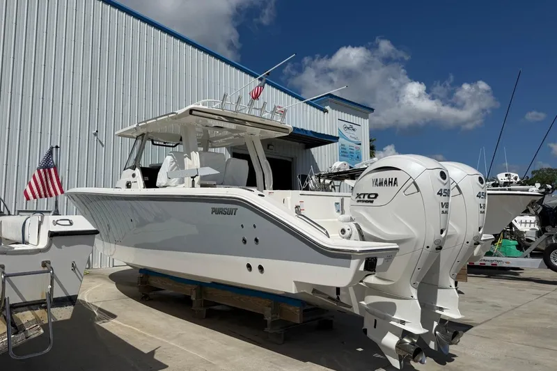 Slide: The Image of 2026 Pursuit S 358 Sport boat with twin Yamaha engines, docked outdoors. - 4