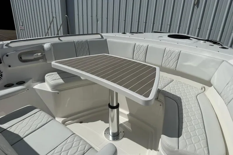 Slide: The Image of Luxurious seating area on 2026 Pursuit S 358 Sport boat with elegant table and cushions. - 40
