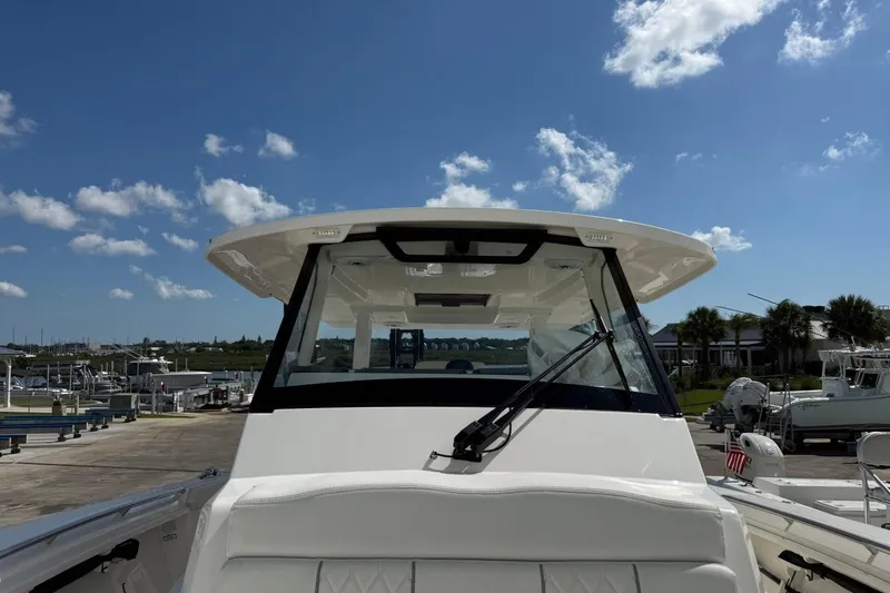 Slide: The Image of 2026 Pursuit S 358 Sport boat docked under a clear blue sky. - 46