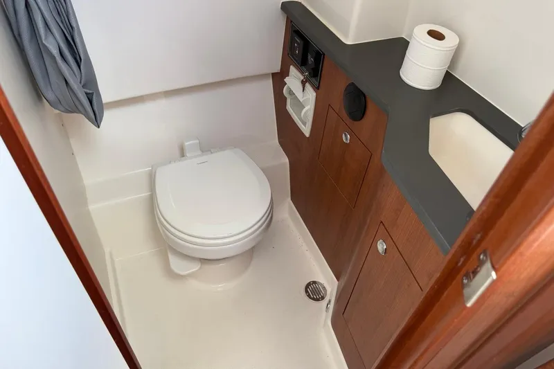 Slide: The Image of Compact bathroom in 2026 Pursuit S 358 Sport boat with toilet and sink. - 57