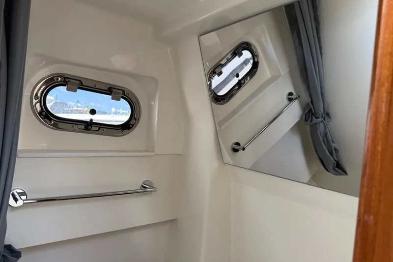Slide: The Image of Interior of 2026 Pursuit S 358 Sport boat with window and mirror. - 58