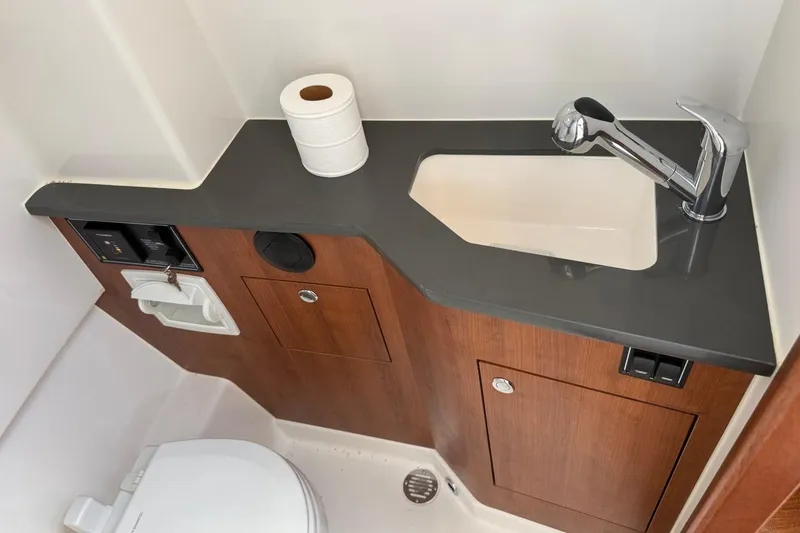 Slide: The Image of 2026 Pursuit S 358 Sport boat bathroom with sink, faucet, and toilet paper roll. - 59