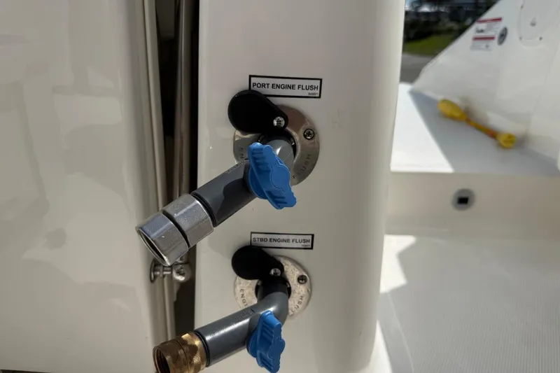 Slide: The Image of 2026 Pursuit S 358 Sport boat engine flush valves with blue handles. - 63