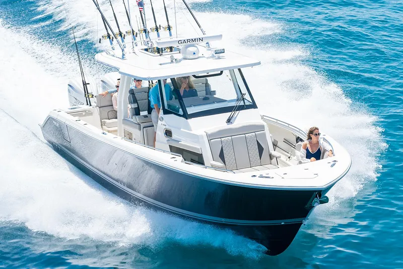 Slide: The Image of Manufacturer Provided Image: 2025 Pursuit S 358 Sport boat cruising on clear blue water. - 65
