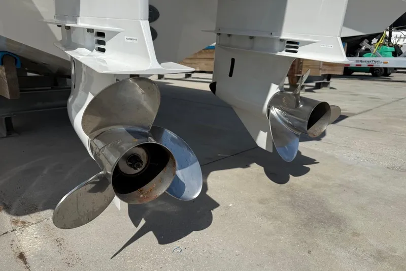 Slide: The Image of Twin propellers of a 2026 Pursuit S 358 Sport boat on a concrete surface. - 7