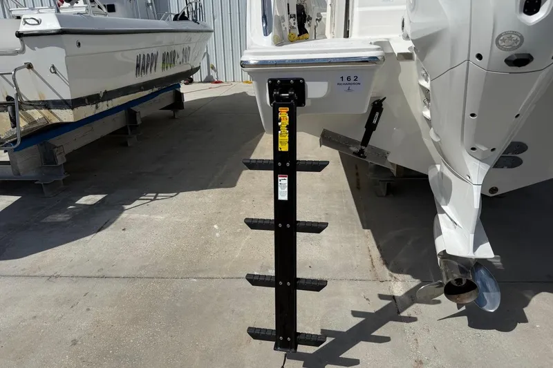Slide: The Image of 2026 Pursuit S 358 Sport boat with ladder and outboard motor in a marina. - 8