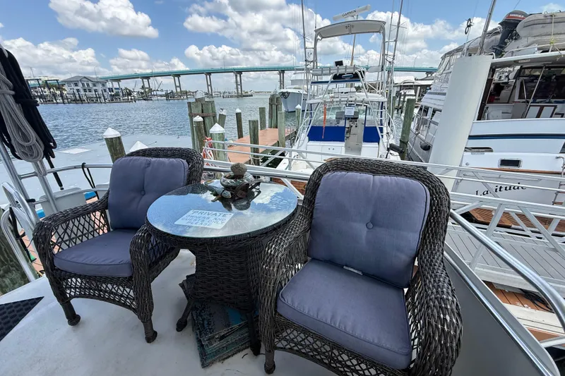 Slide: The Image of Cozy seating on 1995 Mainship 37 Motor Yacht with marina view. - 12