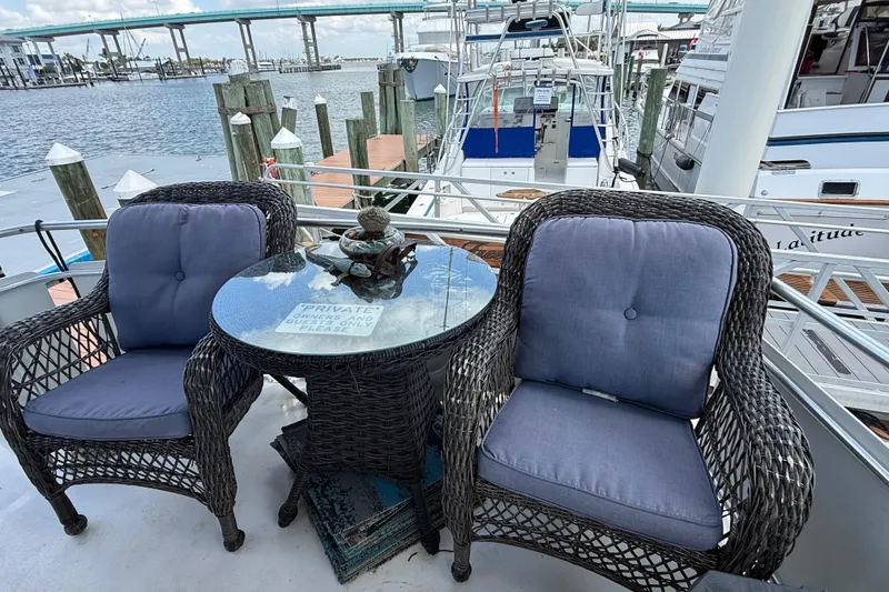 Slide: The Image of Wicker chairs and table on 1995 Mainship 37 Motor Yacht deck, overlooking marina. - 13