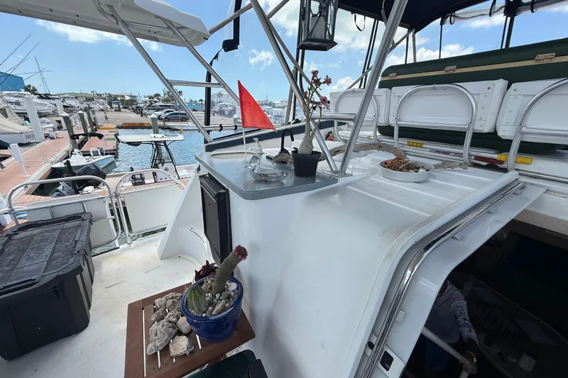 Slide: The Image of 1995 Mainship 37 Motor Yacht deck with plants and marina view. - 14