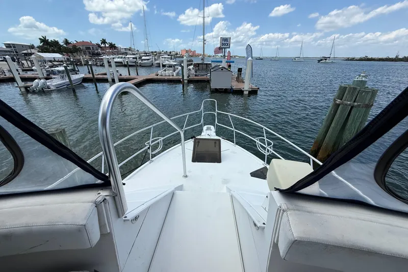 Slide: The Image of 1995 Mainship 37 Motor Yacht docked at marina, clear sky, calm water. - 19