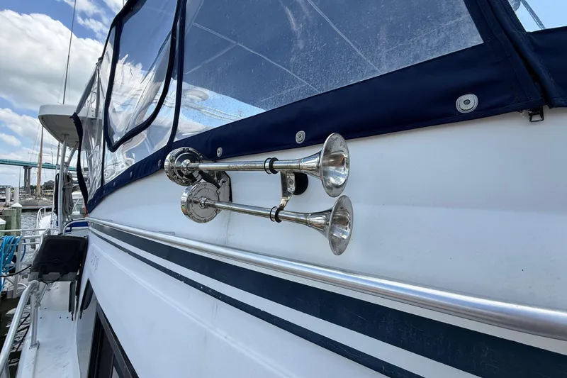 Slide: The Image of 1995 Mainship 37 Motor Yacht with dual chrome horns and blue canopy. - 22