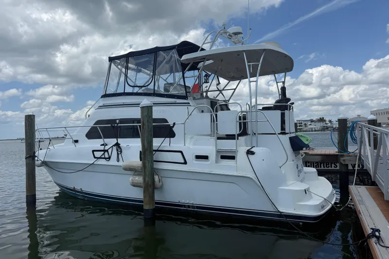 Slide: The Image of 1995 Mainship 37 Motor Yacht docked under cloudy sky. - 26