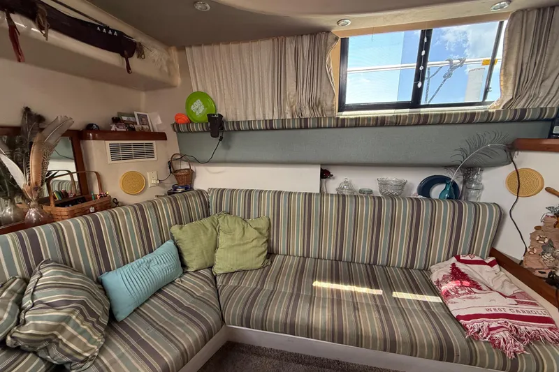 Slide: The Image of Cozy interior of 1995 Mainship 37 Motor Yacht with striped seating and decorative accents. - 9